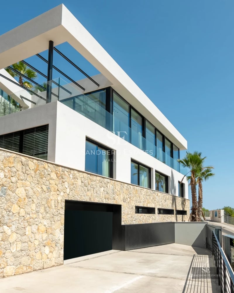 Spacious balcony with panoramic sea views. Modern design with glass railing and stylish outdoor furniture.