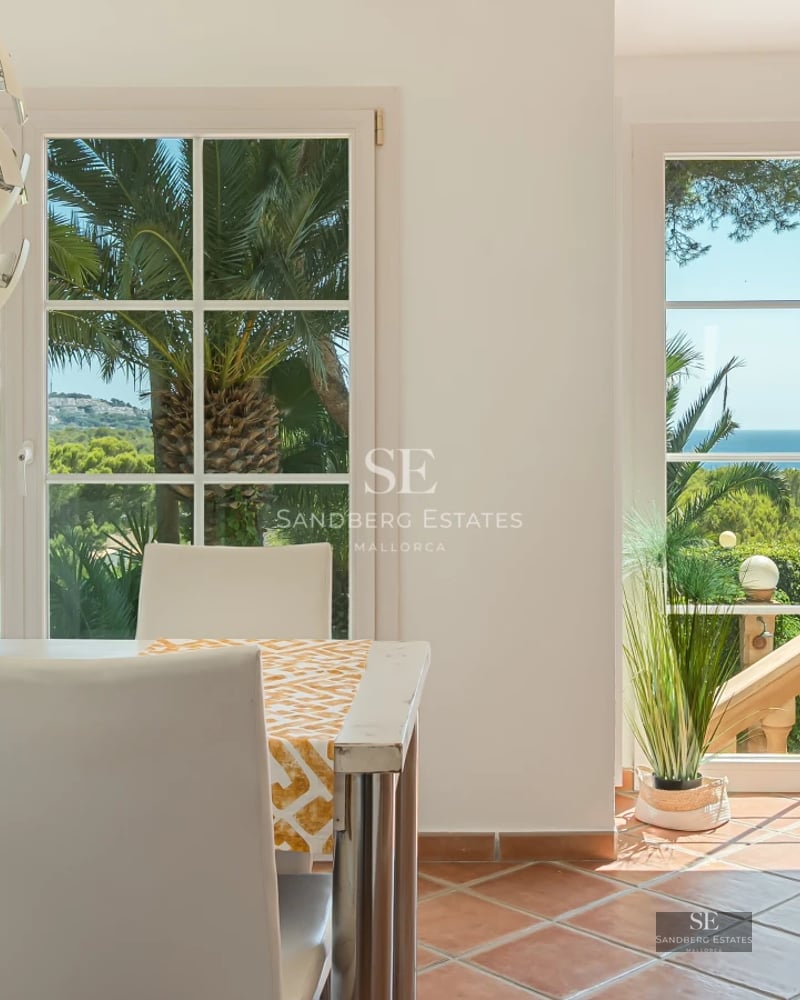 Exterior view of modern villa featuring an infinity pool, expansive terraces, and lush vegetation. Contemporary architectural design.