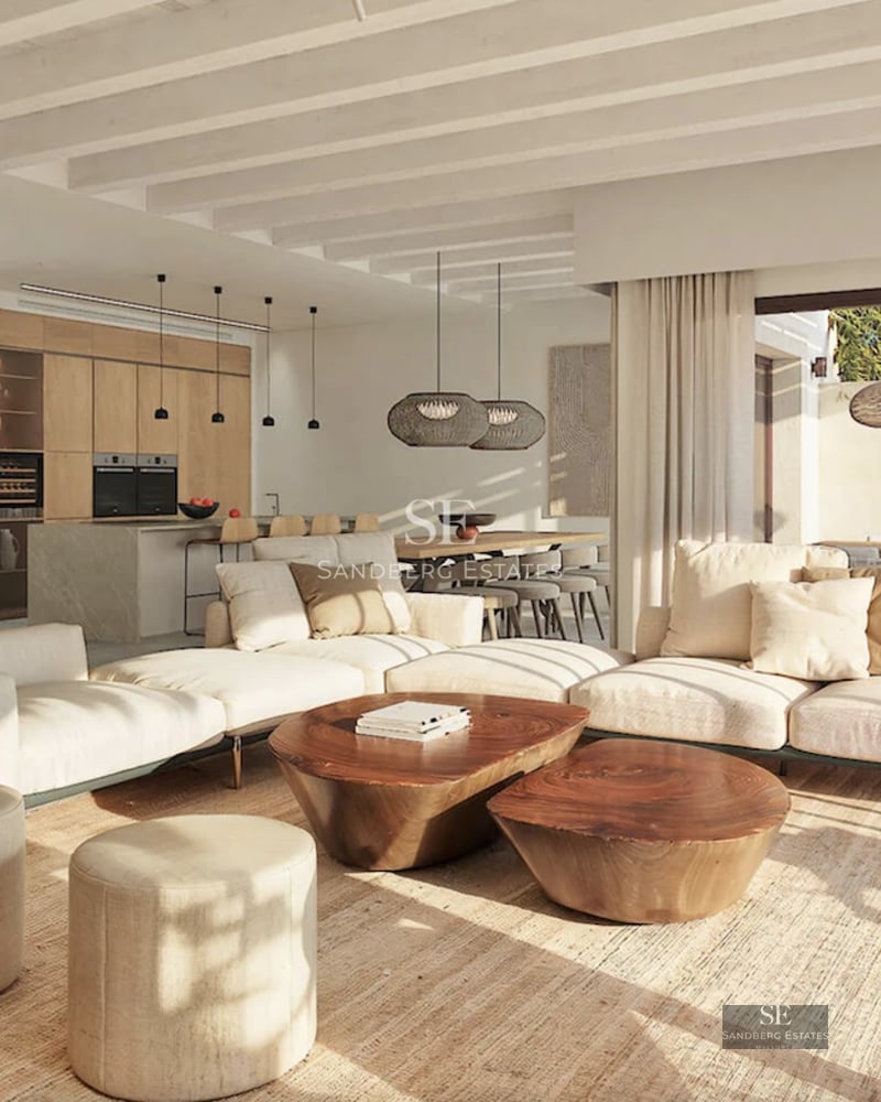 Aerial view of a modern house with infinity pool and large green areas. Minimalist architecture with a predominantly white facade.