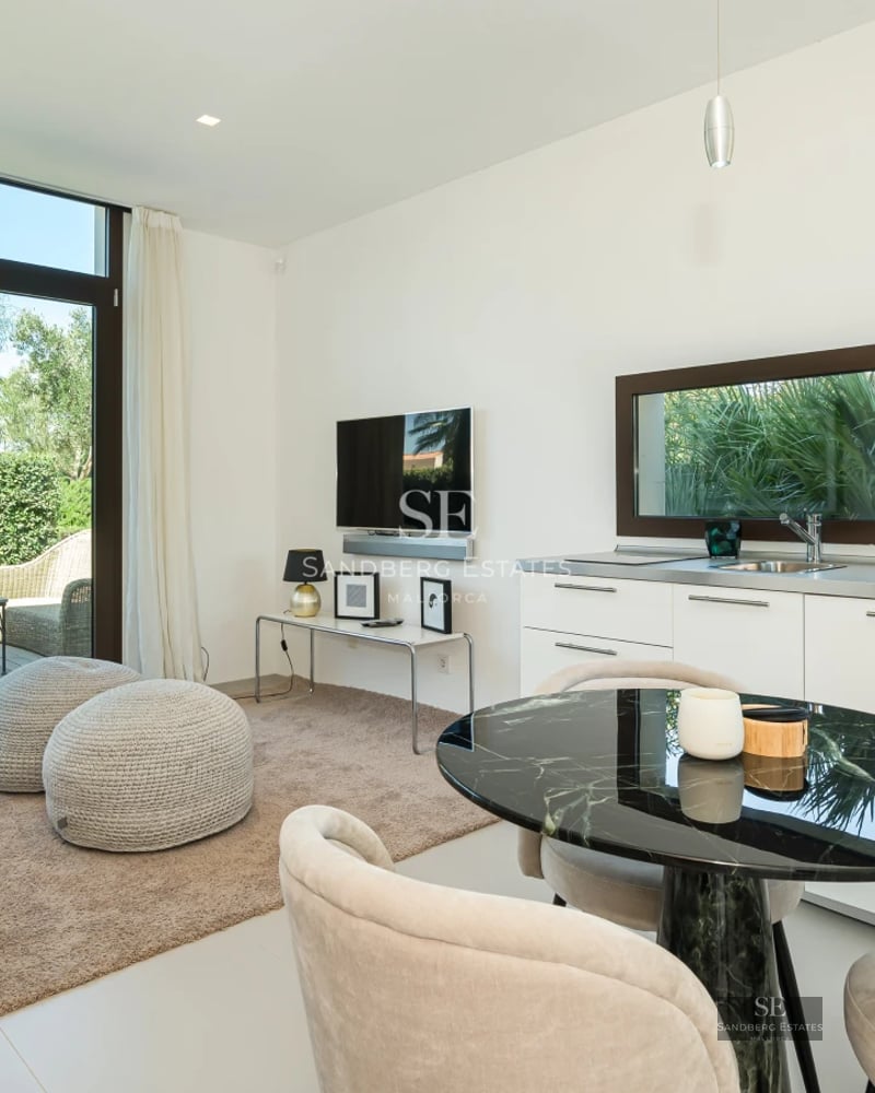 Spacious terrace with infinity pool, sun loungers, and panoramic sea views. Modern design featuring clean lines and lush vegetation.