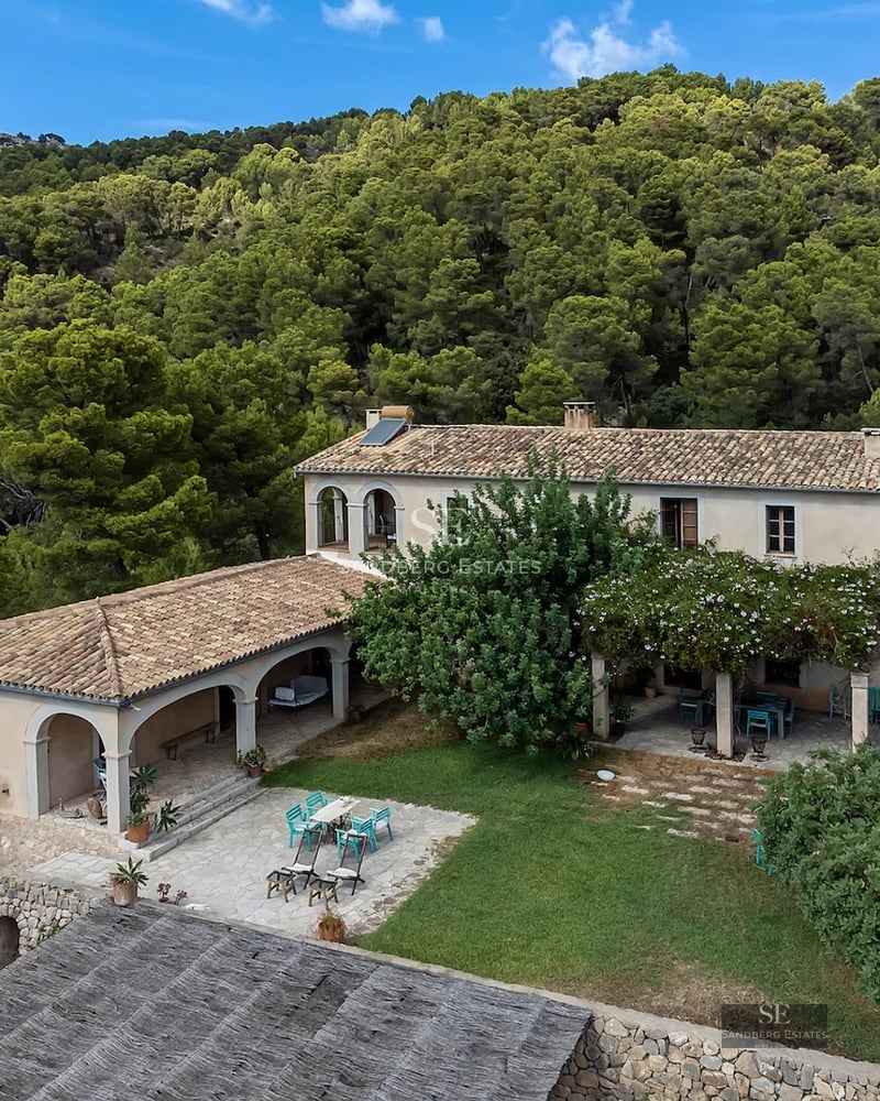 Exterior view of a modern villa featuring an infinity pool, large garden, and minimalist architecture. Warm lighting and lush vegetation.