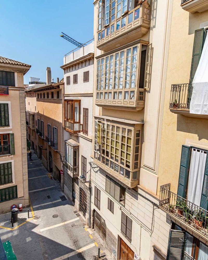 Panoramic view of a modern living room with large windows offering stunning sea views. Minimalist and elegant design.