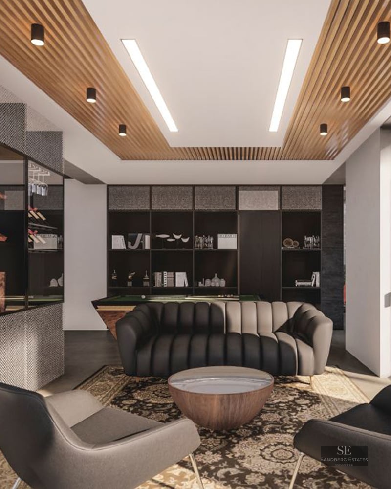 Modern game room featuring a pool table, dark leather sofa, slatted wood ceiling, and glass-walled wine display.