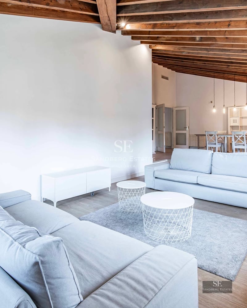Wide view of modern villa with infinity pool. Minimalist design, large windows, and lush vegetation.