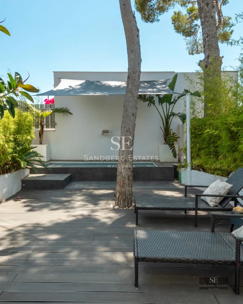 Expansive terrace featuring an infinity pool, sun loungers, and ocean views. Modern architecture and minimalist design.