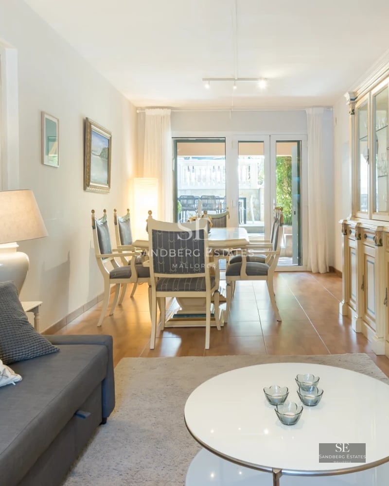 Spacious living room with balcony, panoramic sea views. Modern, bright, and elegant design. High-quality furniture, neutral color palette.