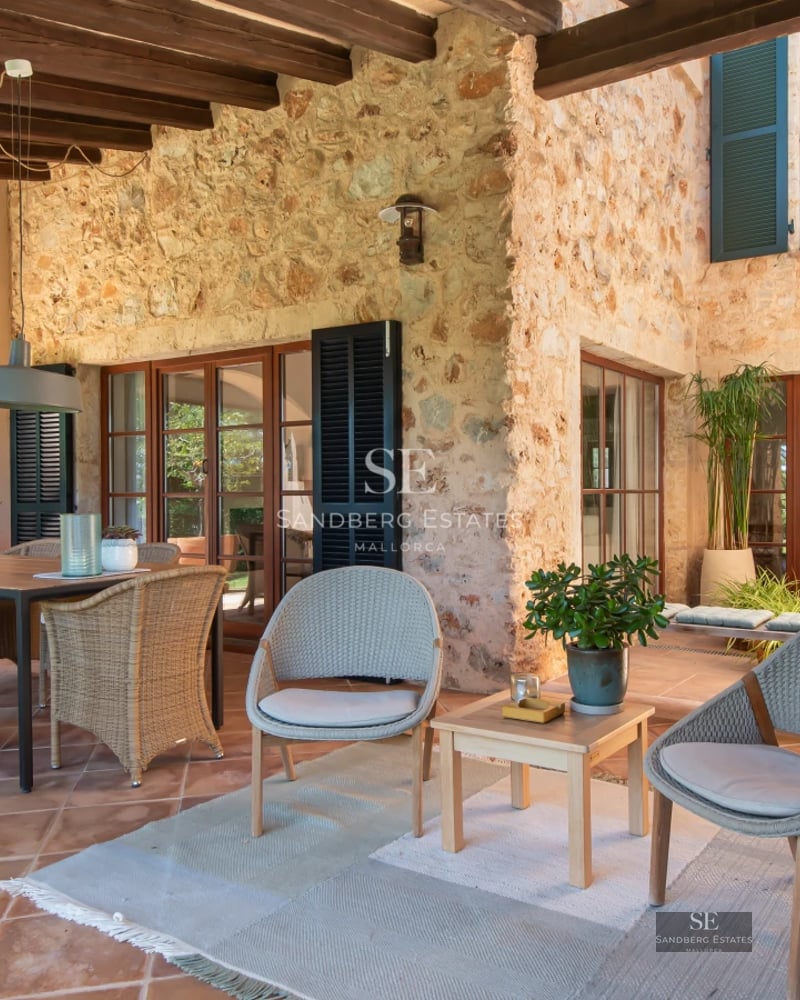 Bright living room featuring large windows offering panoramic sea views. Modern interior design with elegant furniture and light wood flooring.