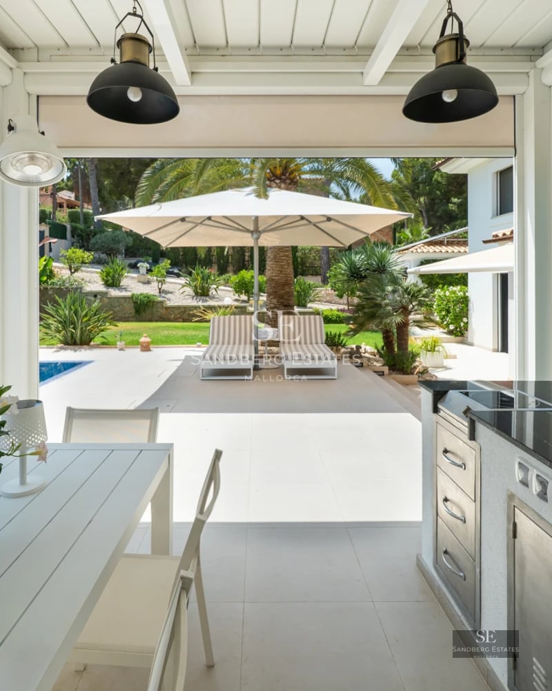 Exterior view of a modern house with a pool. Minimalist design, large windows, and manicured gardens.