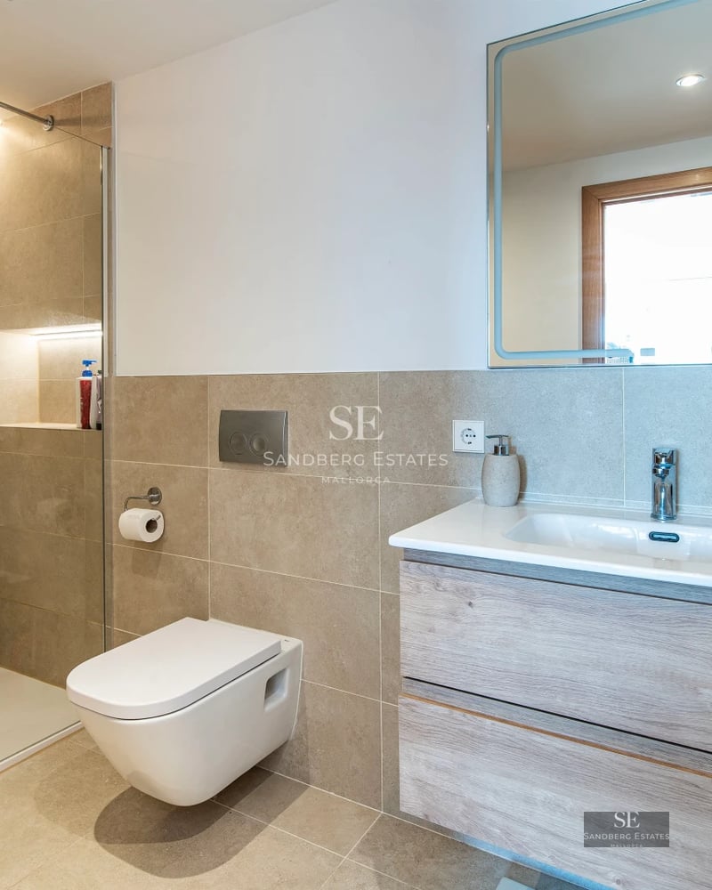 Spacious living room with panoramic windows, light wood flooring, modern fireplace, and designer furniture. Exceptional natural light.