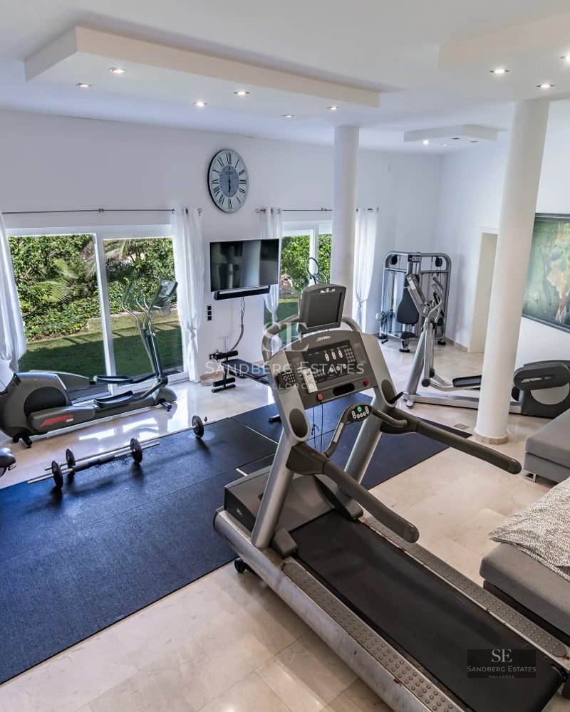 Spacious balcony overlooking the sea. Glass railing, wooden flooring. Modern and elegant design. Minimalist outdoor furniture.