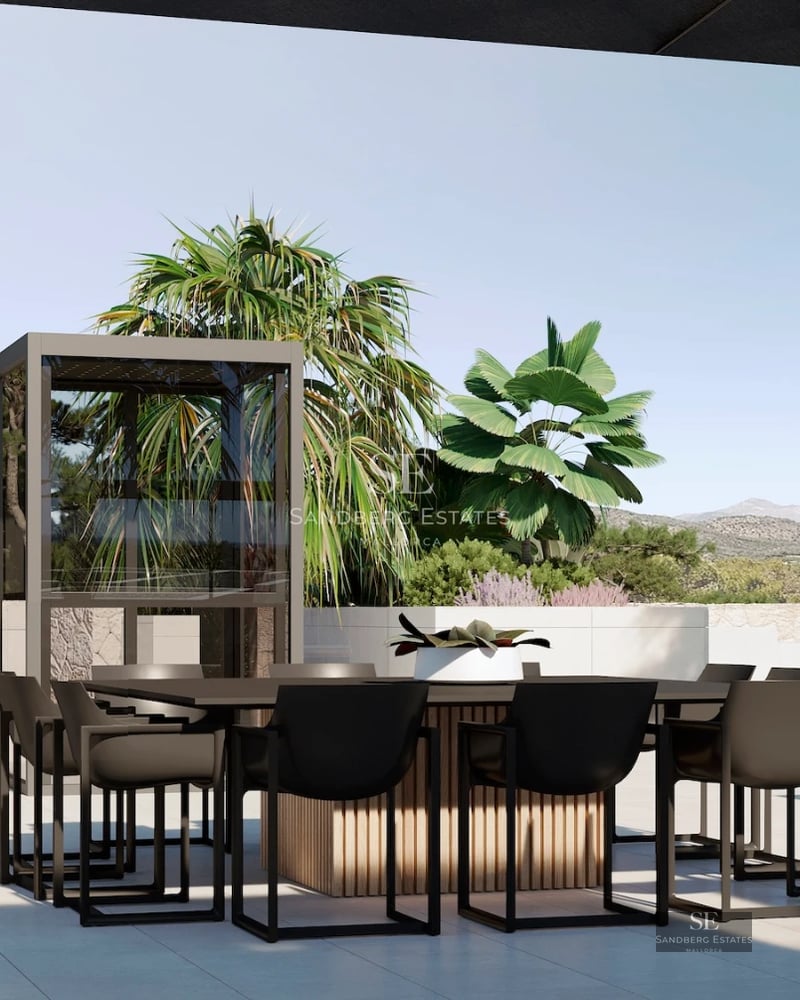 View of the infinity pool with white armchairs and a modern villa with large windows. Green lawn and clear sky.