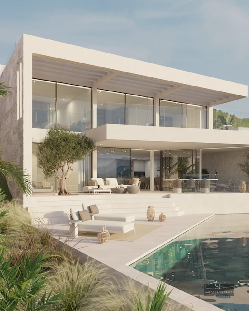 Modern two-story villa with white facade, floor-to-ceiling windows, infinity pool, and sun loungers.
