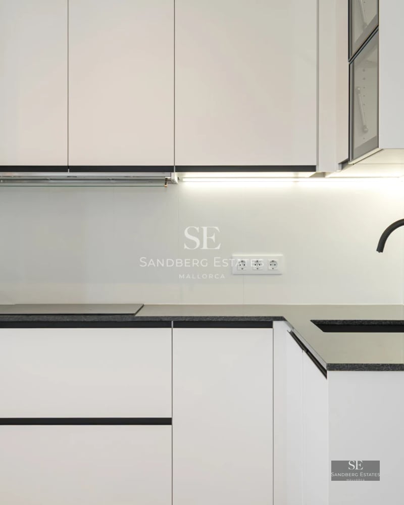 Bright, spacious living room with pool visible through large windows. Modern design, stylish furniture, and pops of color.