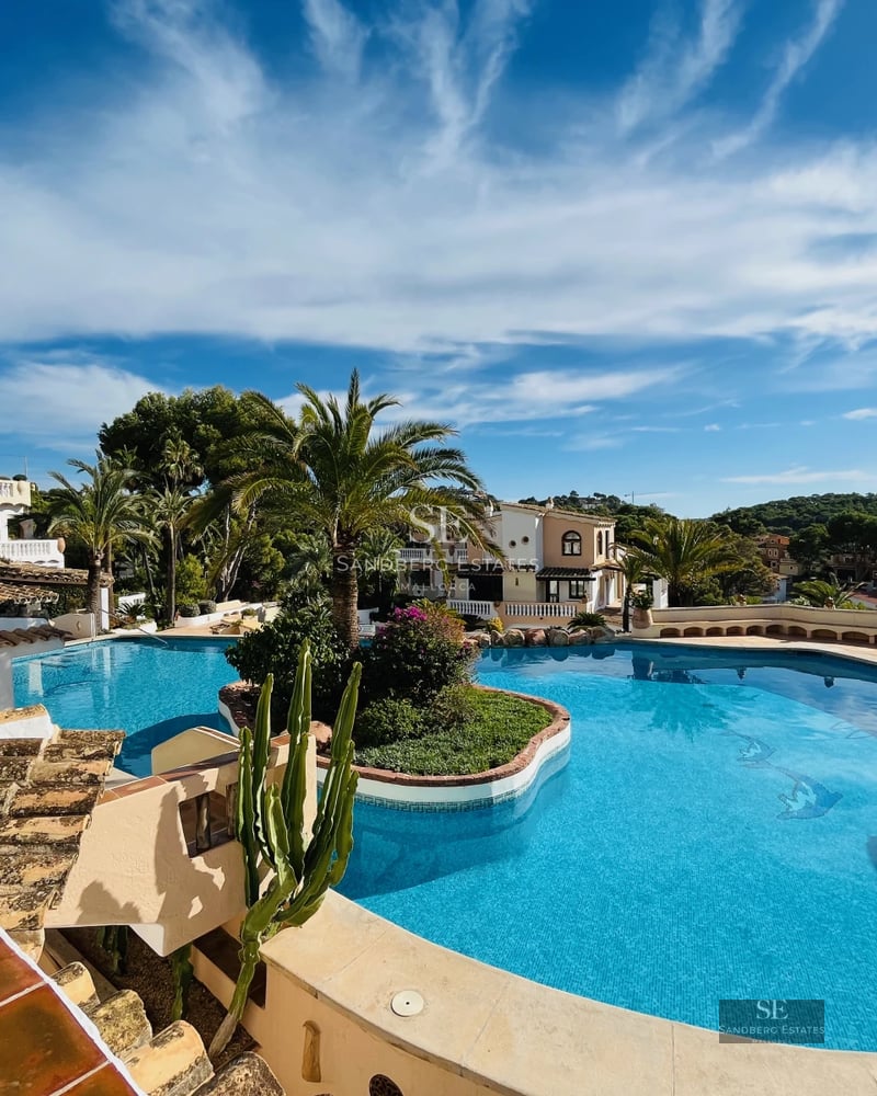 Expansive terrace with infinity pool, sea views and modern furniture. Sleek, minimalist design. Natural lighting.