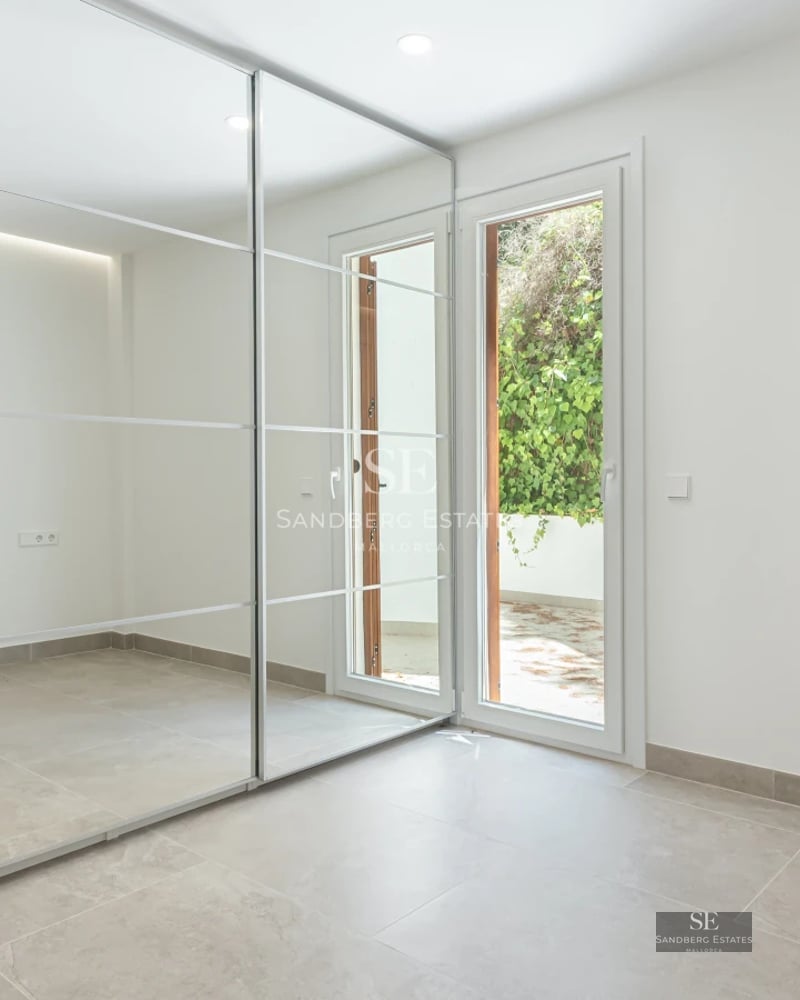 Spacious terrace with sea view, modern furniture, wooden floors, glass railing. Contemporary design.