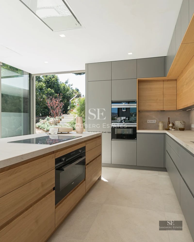 Expansive terrace featuring an infinity pool with panoramic sea views. Modern architecture, clean lines, and stylish outdoor furniture.