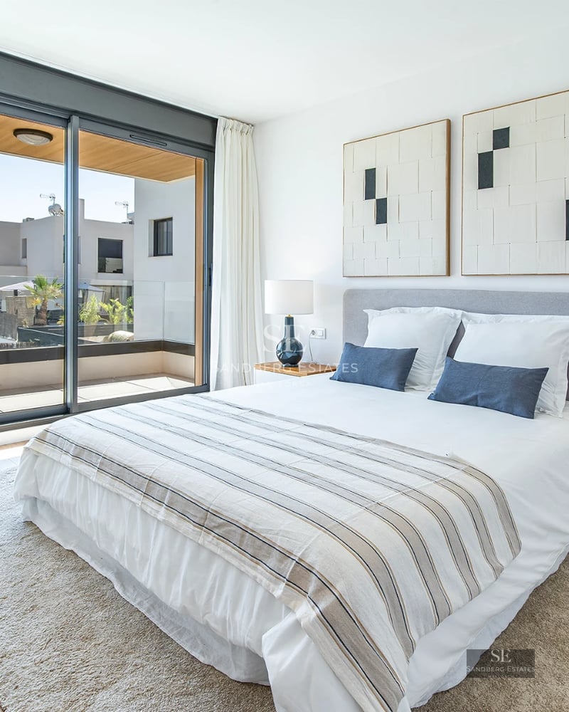 Exterior view of a modern house with a pool, manicured garden, and large windows providing ample natural light.