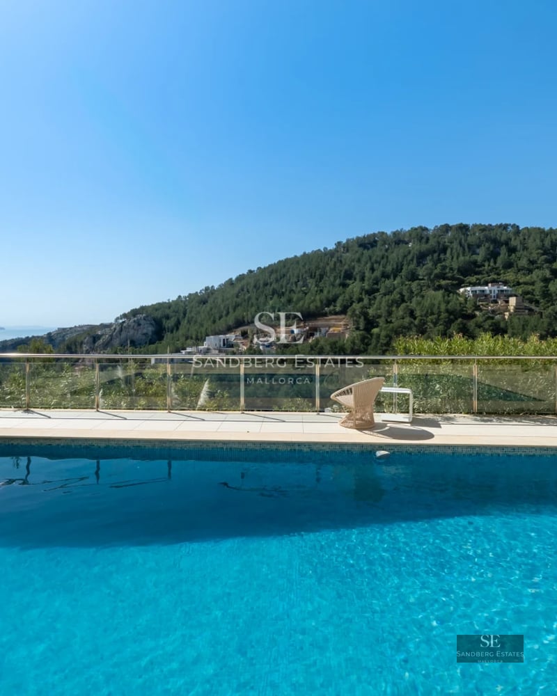 Exterior view of a luxurious property with a pool, garden, terrace, and modern design. Natural lighting and high-quality materials.