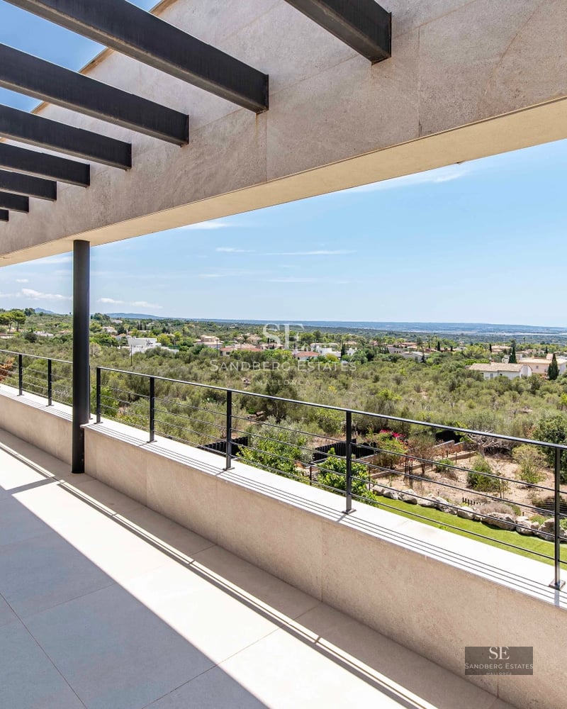 Spacious terrace with infinity pool, sun loungers, and ocean view. Sleek, modern design with high-end finishes.