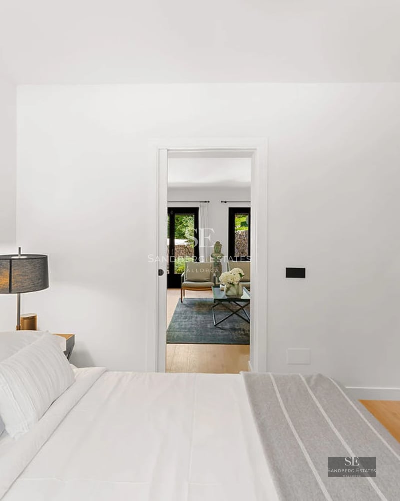 Image of a villa featuring a modern and elegant design pool. Bright interior with large windows. Lush garden and swimming pool.