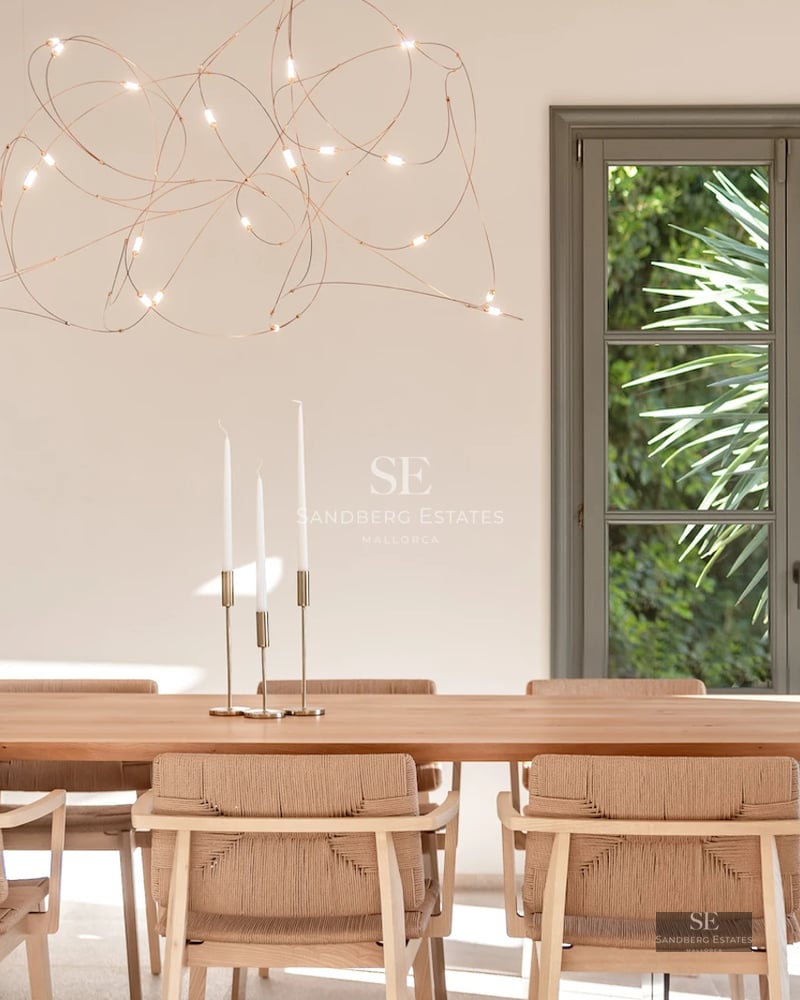 Spacious living room with floor-to-ceiling sea view windows. Modern design, light wood floors, minimalist furniture, and abundant natural light.