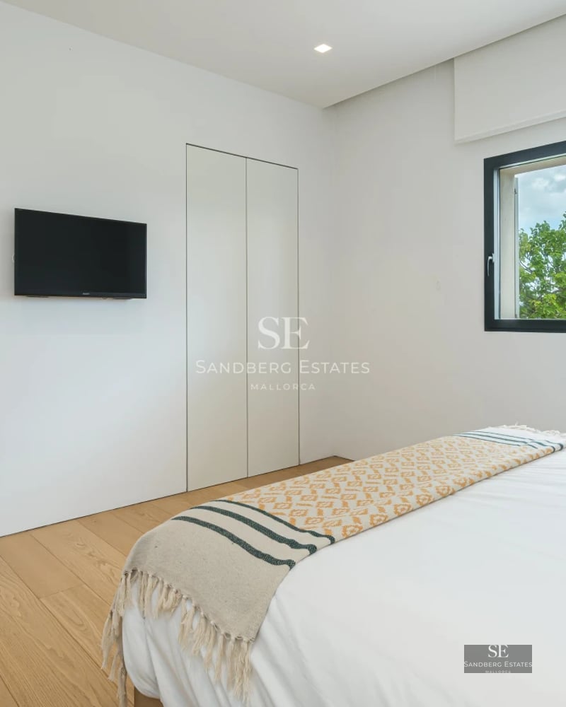 Spacious terrace with modern furniture, panoramic view, and minimalist design. Wood flooring and glass railing.