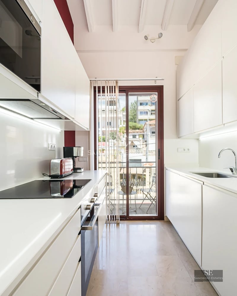 Exterior view of a modern house with an infinity pool, lush garden, and minimalist natural stone facade. Warm lighting.