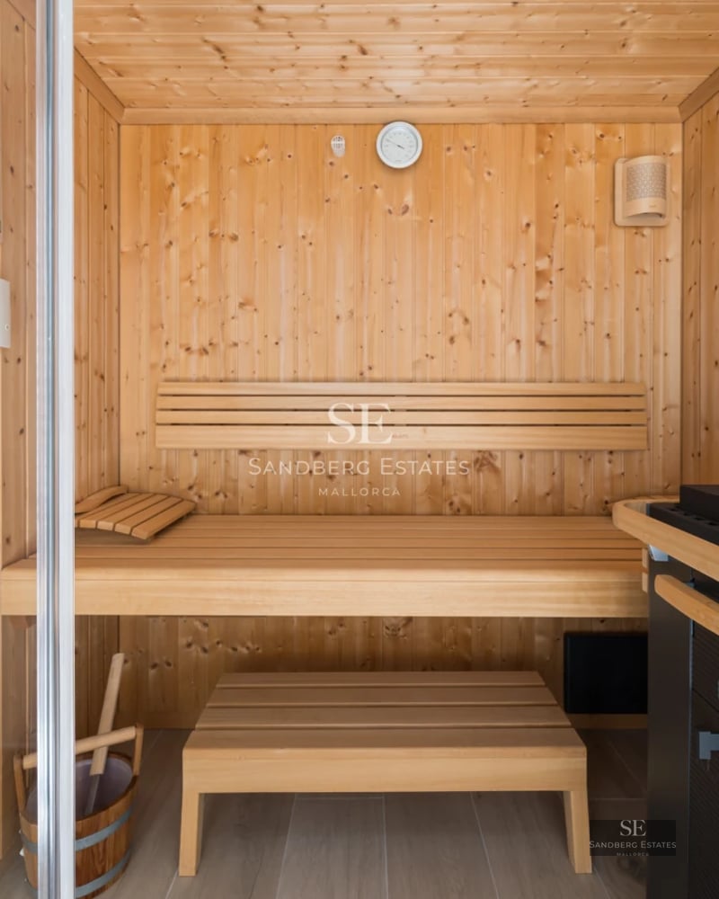 Spacious balcony with sea view. Modern design, glass railing, light tile flooring. Bright and elegant space.