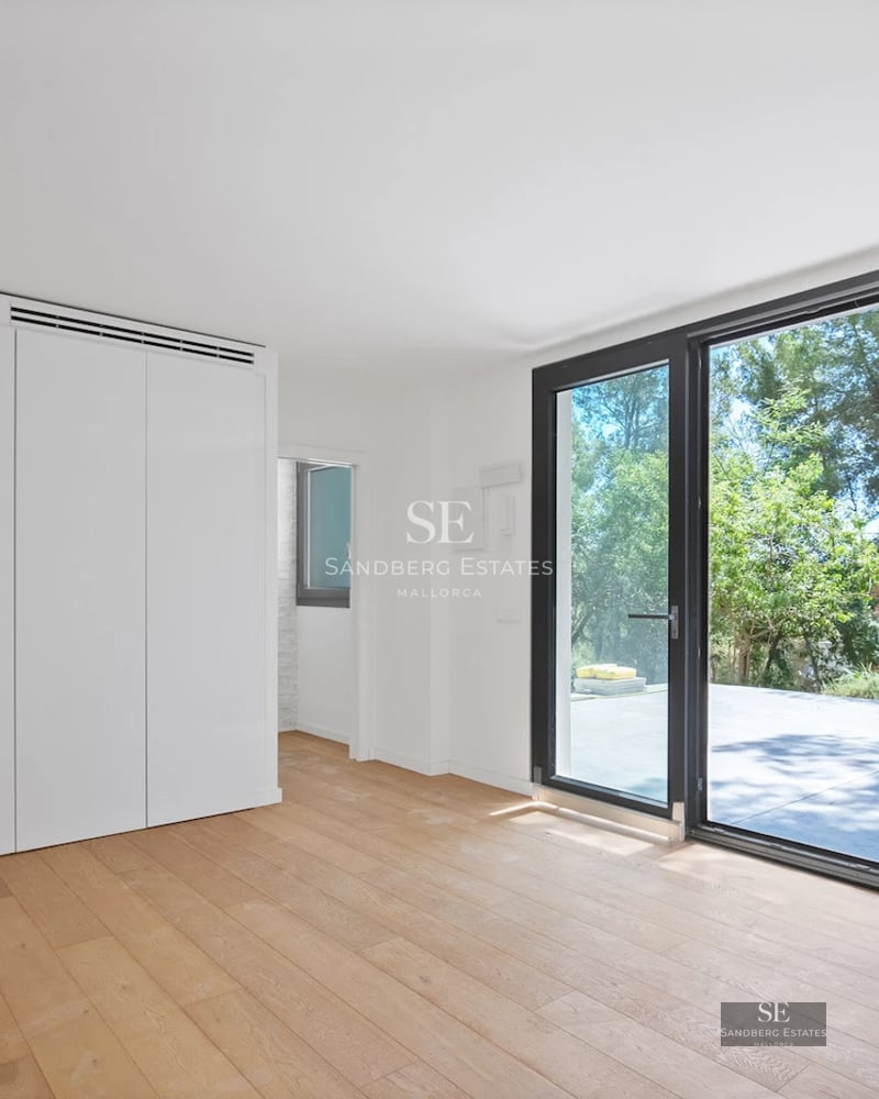 Wide view of a modern villa with a reflecting pool. Minimalist design with large windows and a spacious terrace.