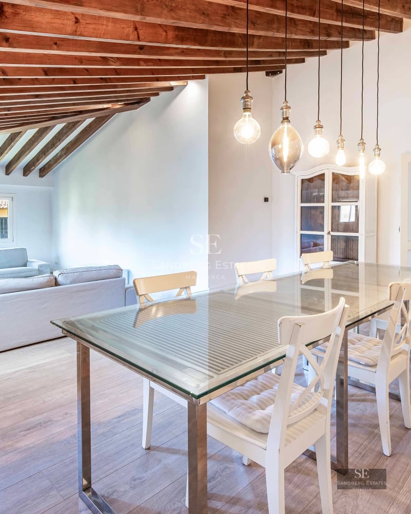 Property view with illuminated pool at sunset. Modern architecture, expansive terraces and lush vegetation. Luxury and comfort.