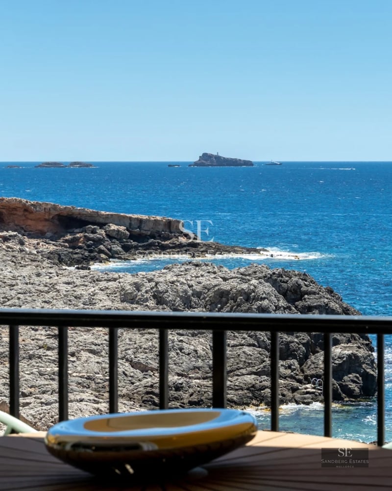 View of a luxurious villa with a pool, surrounded by greenery. Modern design, large windows, and high-quality finishes.