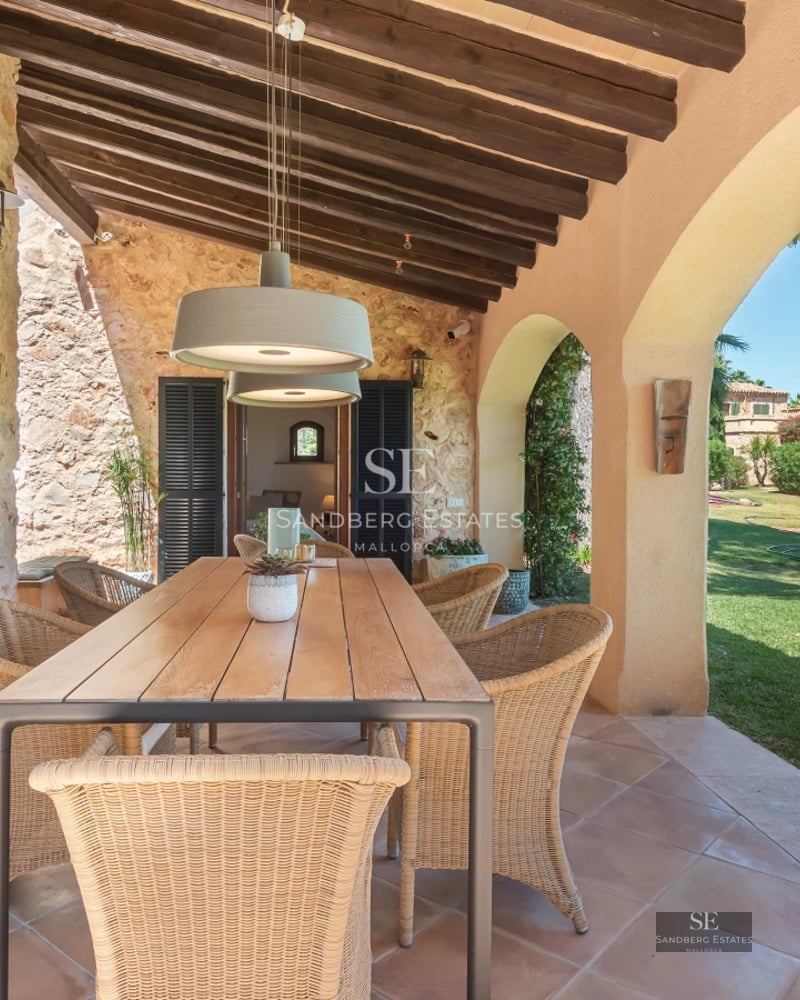 View of a luxurious villa with infinity pool, spacious terraces, and modern design. Lush gardens and panoramic views.