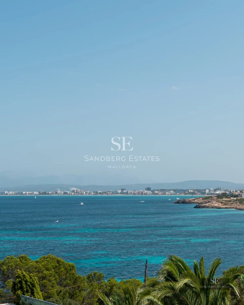 Aerial view of a modern villa featuring a turquoise pool, manicured gardens, and minimalist architecture. Natural lighting.