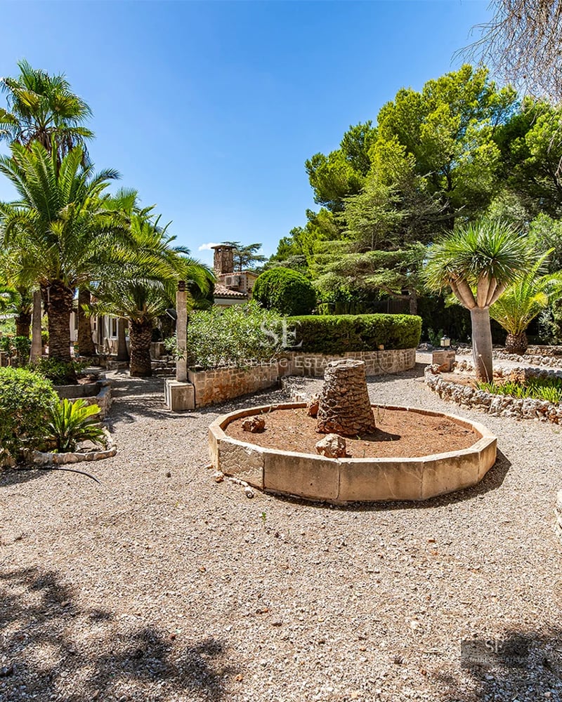Exterior view of a modern villa featuring an infinity pool, expansive terraces, minimalist design with large windows, and lush landscaping.