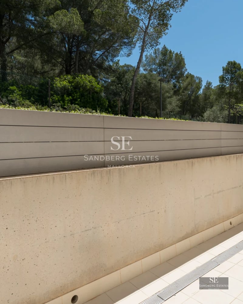 Spacious balcony with panoramic sea views. Modern design, glass railing, and elegant furniture. Ambient lighting.