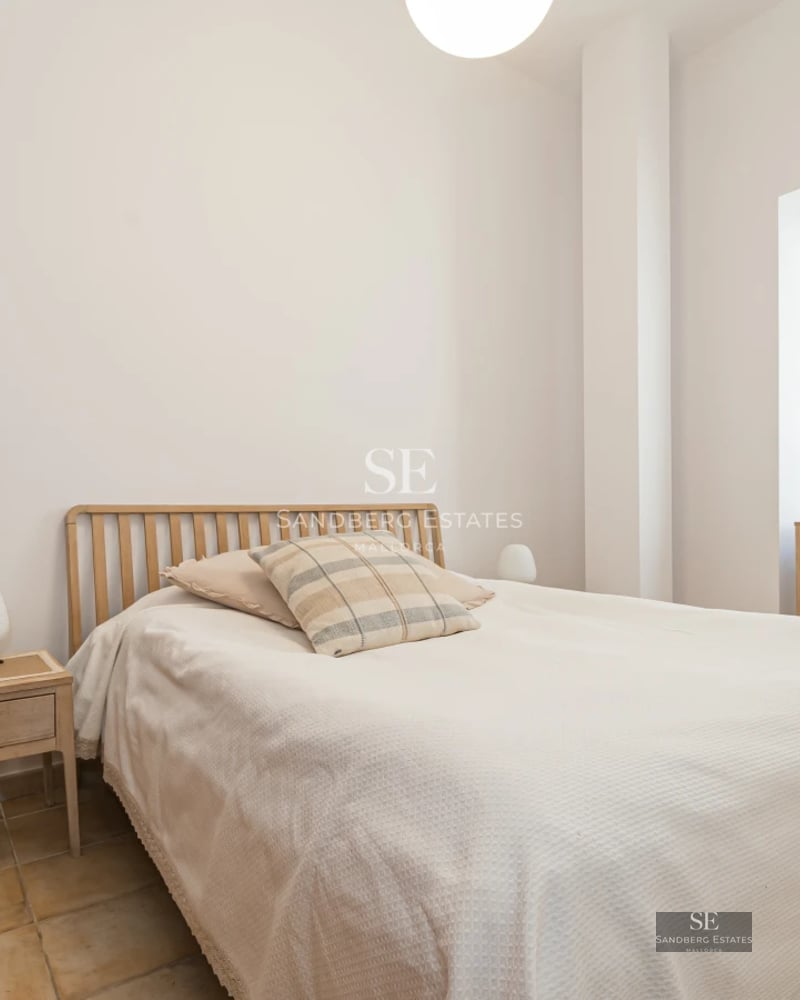 Exterior view of a modern house featuring a reflective pool, lush garden, and spacious patio. Sleek and contemporary architectural design.