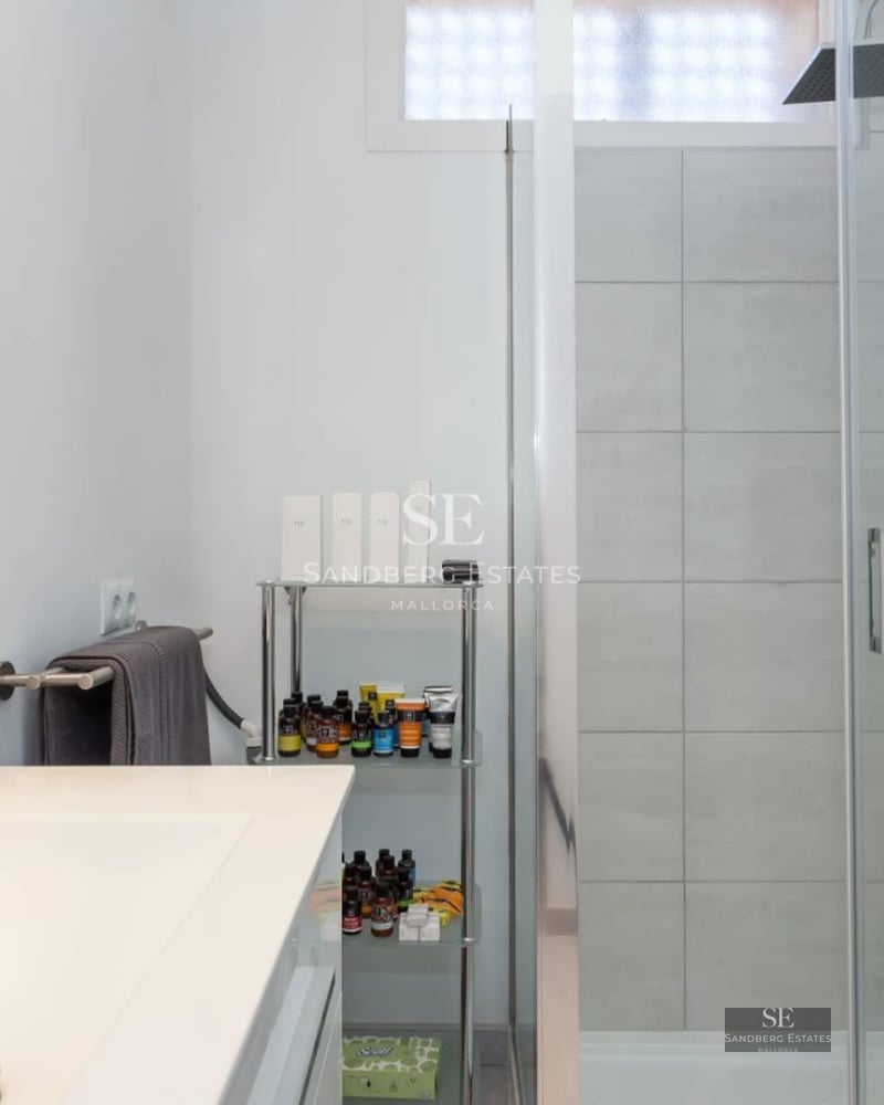 Exterior view of a modern villa featuring a swimming pool, large windows and minimalist design. Lush garden and blue sky.