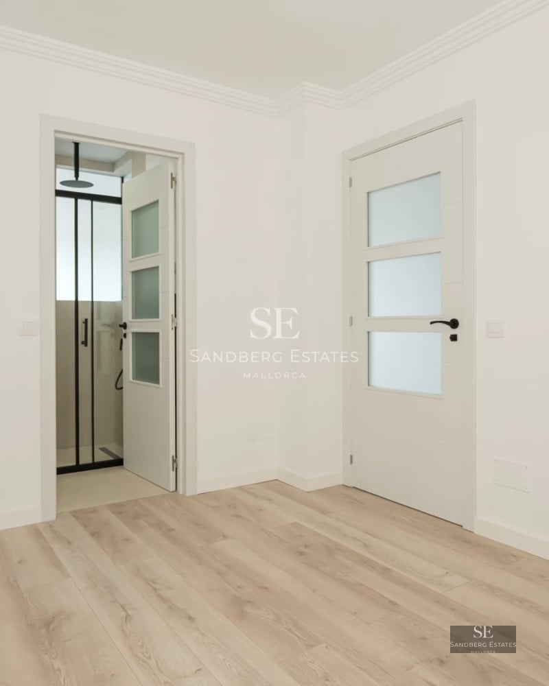 Exterior view of a modern villa featuring a pool, garden, and minimalist architectural design. Large windows reflecting natural light.