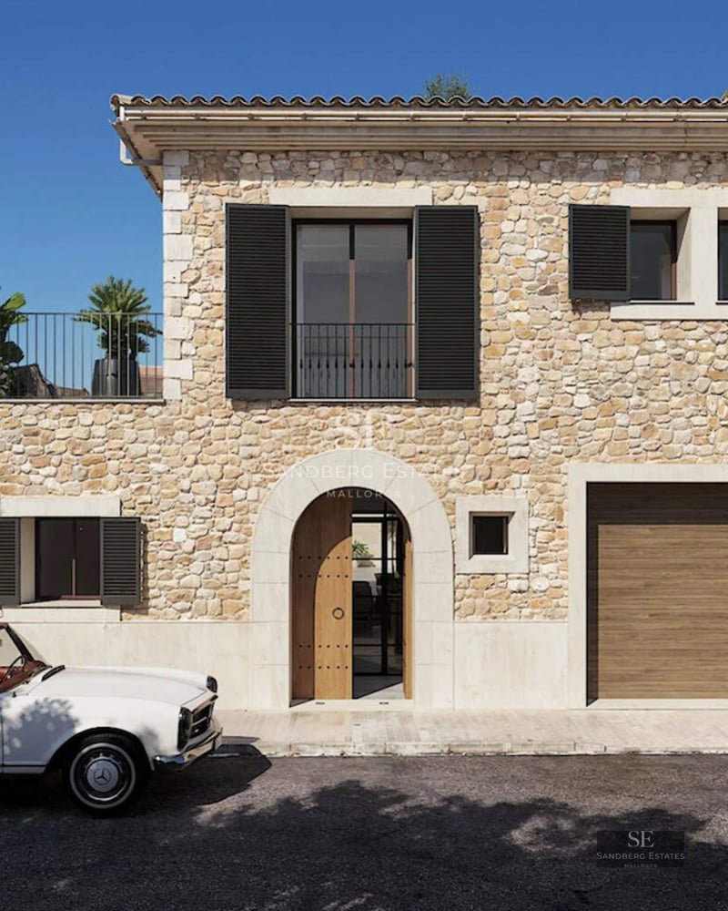 Bright living room with panoramic sea views. Modern interior featuring large windows, wooden floors, and minimalist decor.