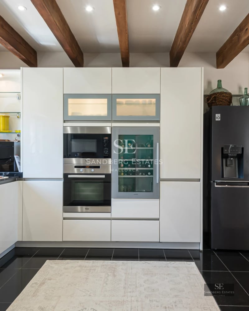 Spacious living room with sea view, balcony, modern furniture, neutral color palette, abundant natural light, and high-quality finishes.