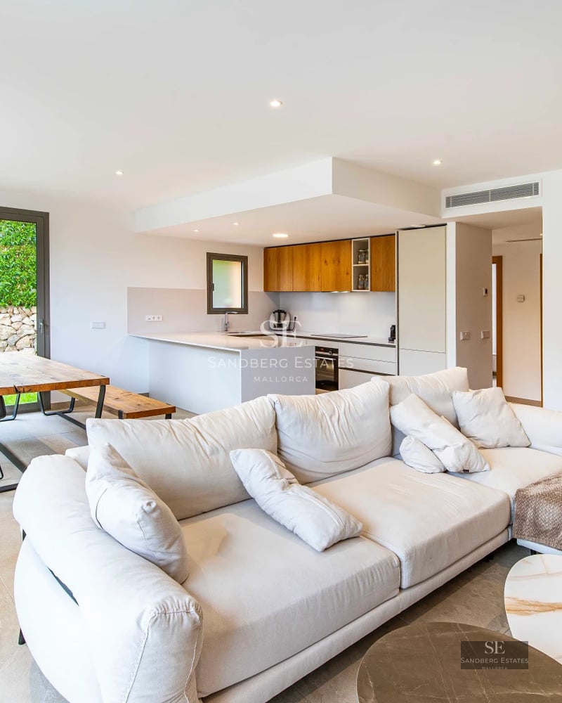 Exterior view of a modern villa with a pool, lush garden, and large terraces. Contemporary architecture with clean lines and large windows.