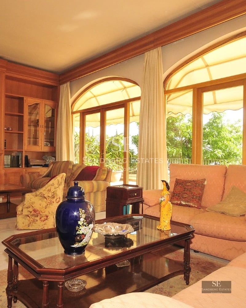 Exterior of a modern villa with pool, palm trees, and large windows. Minimalist and elegant design. Natural lighting.