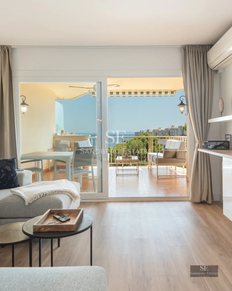 Spacious living room with windows, reflecting pool and modern design. Elegant finishes and abundant natural light. Sophisticated and relaxing space.