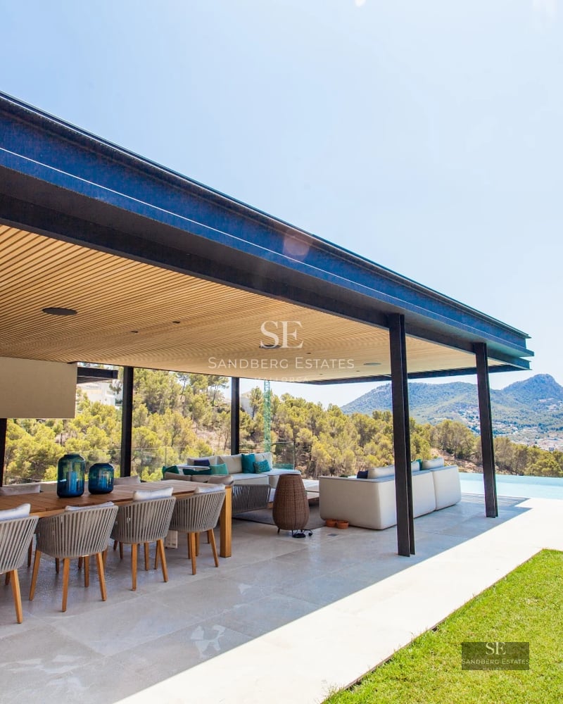 Spacious terrace with pool, sun loungers and panoramic views. Modern design with natural lighting and lush vegetation.