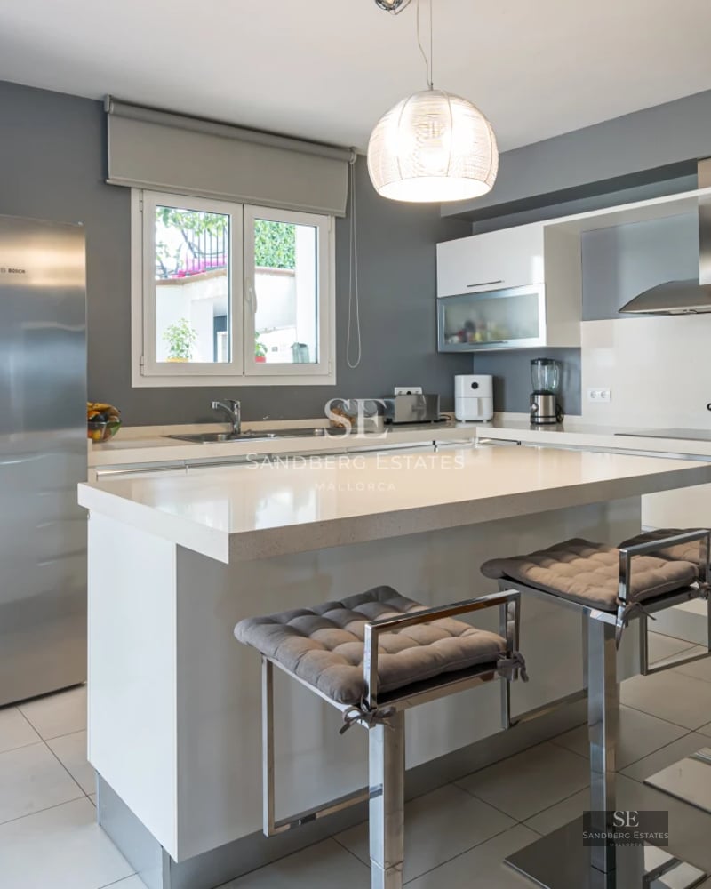 Panoramic view of modern villa with infinity pool, sun loungers, and lush vegetation. Minimalist architecture and landscaping design.