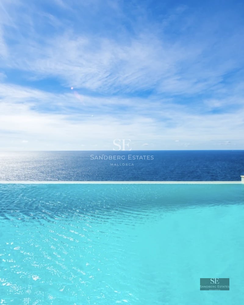 Bright, spacious living room with large windows, light wood floors, and minimalist design. Overlooking garden and pool.