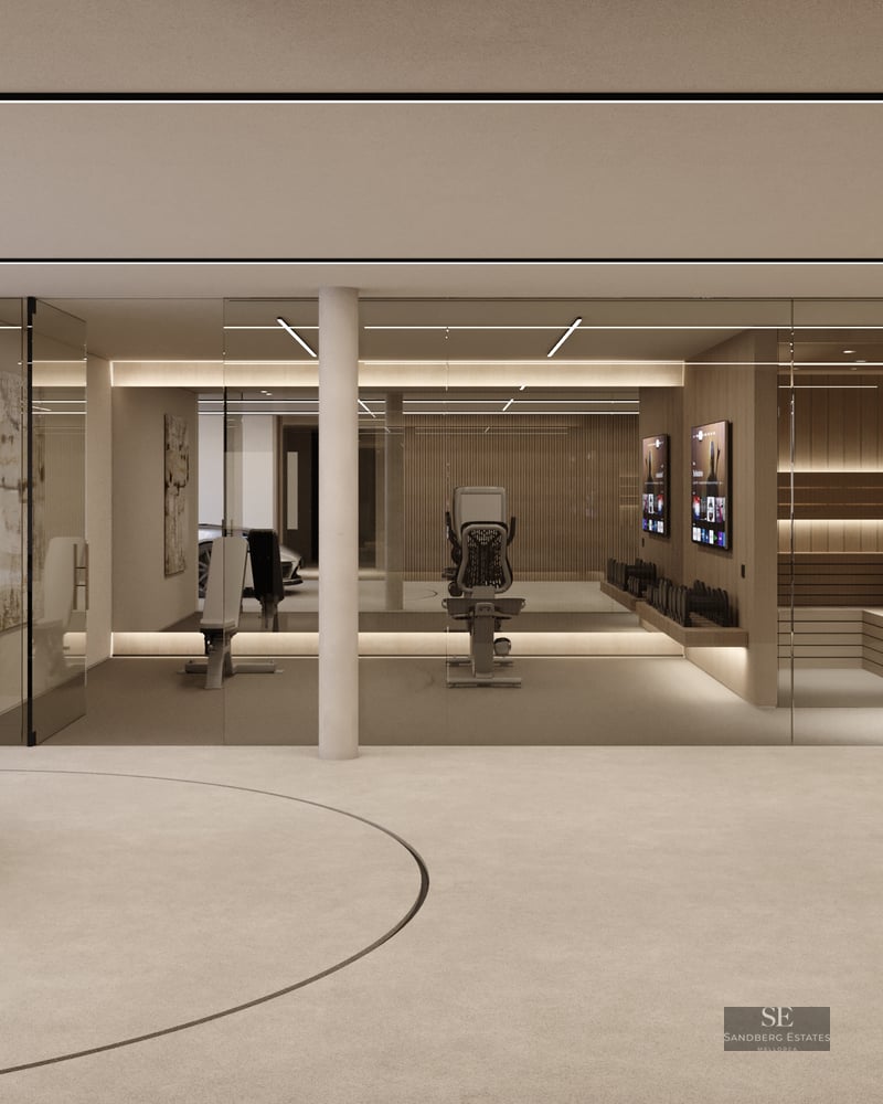 Silver sports car on a turntable in a minimalist garage with a glass-enclosed gym and wooden sauna.