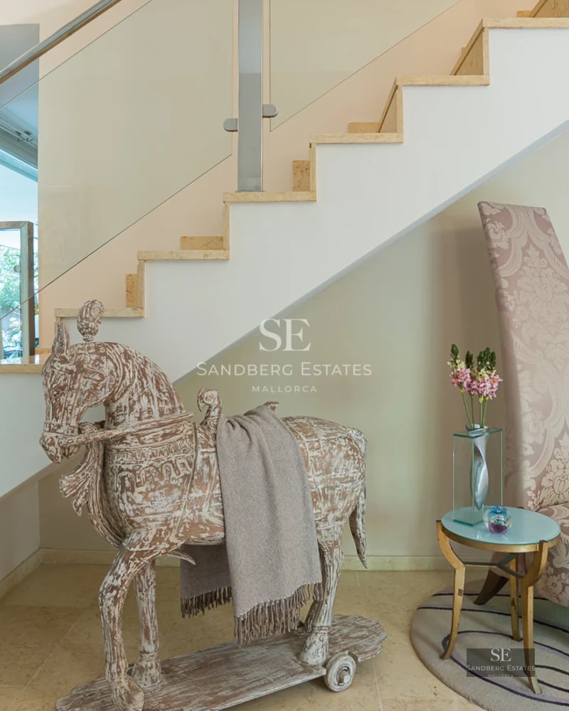 Bright, spacious living room with large windows, modern furniture, and stunning views. Light wood floors and minimalist details.