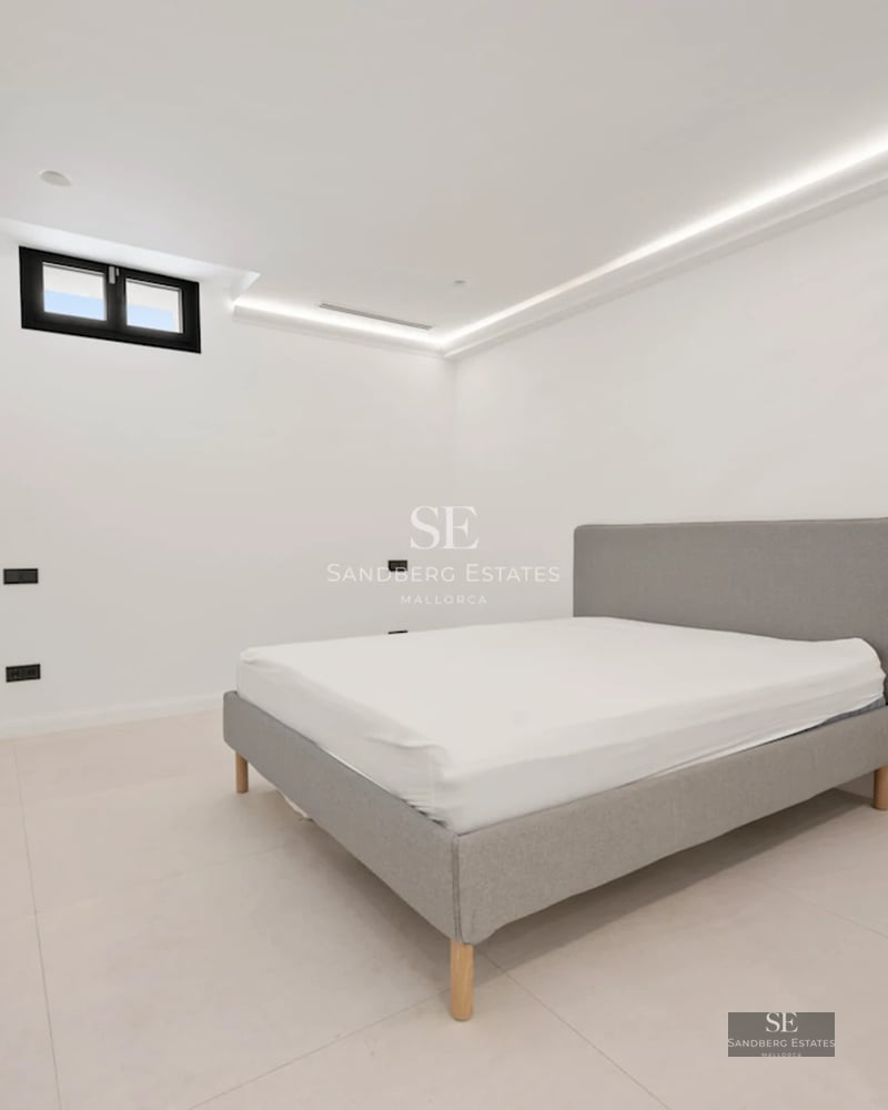 Exterior view of modern villa featuring an infinity pool, large windows, minimalist architecture, and lush garden.