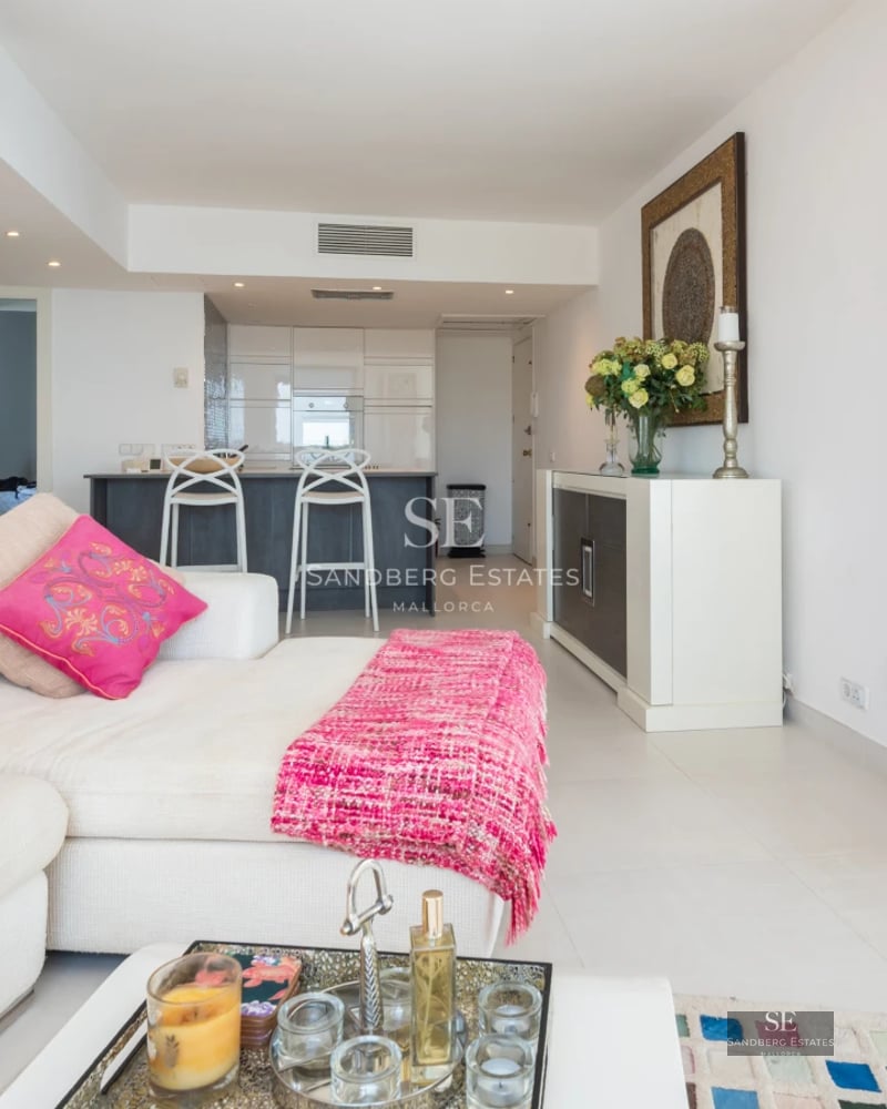 Exterior view of a modern villa with reflective pool, large windows, elegant landscaping, and minimalist architectural design.